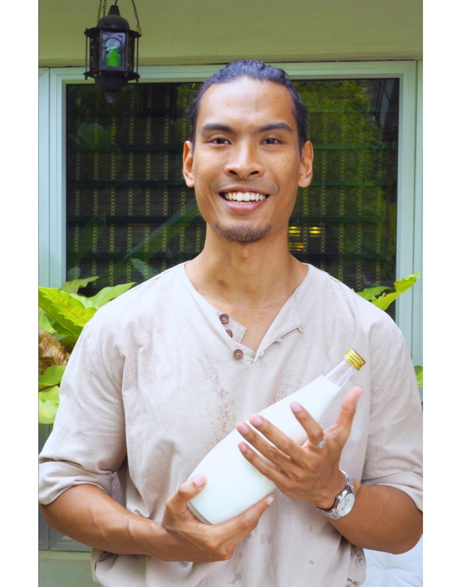 Imran holding a bottle of Pure Physique milk kefir